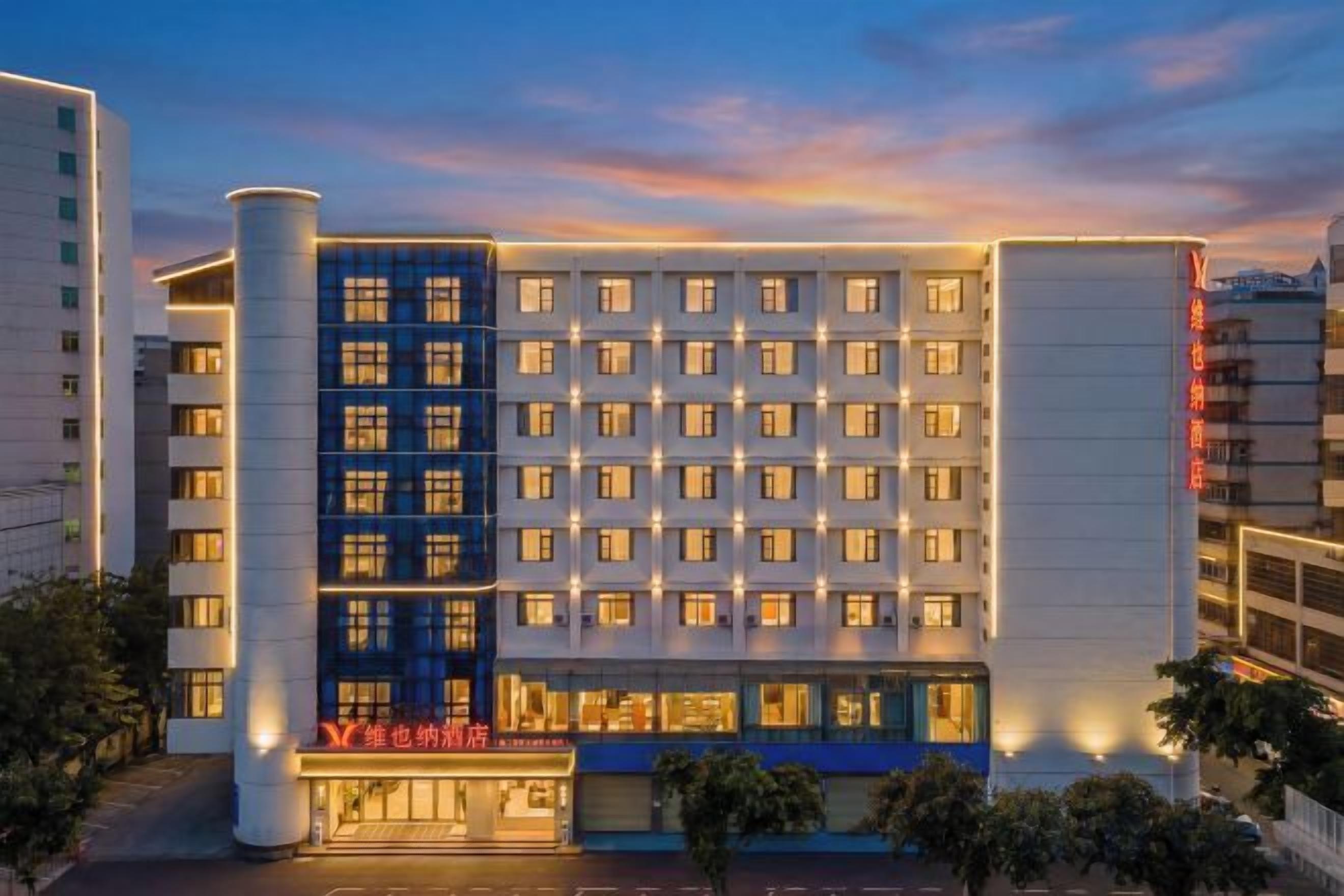 A multi-story hotel with a modern facade, multiple windows, and a prominent entrance.