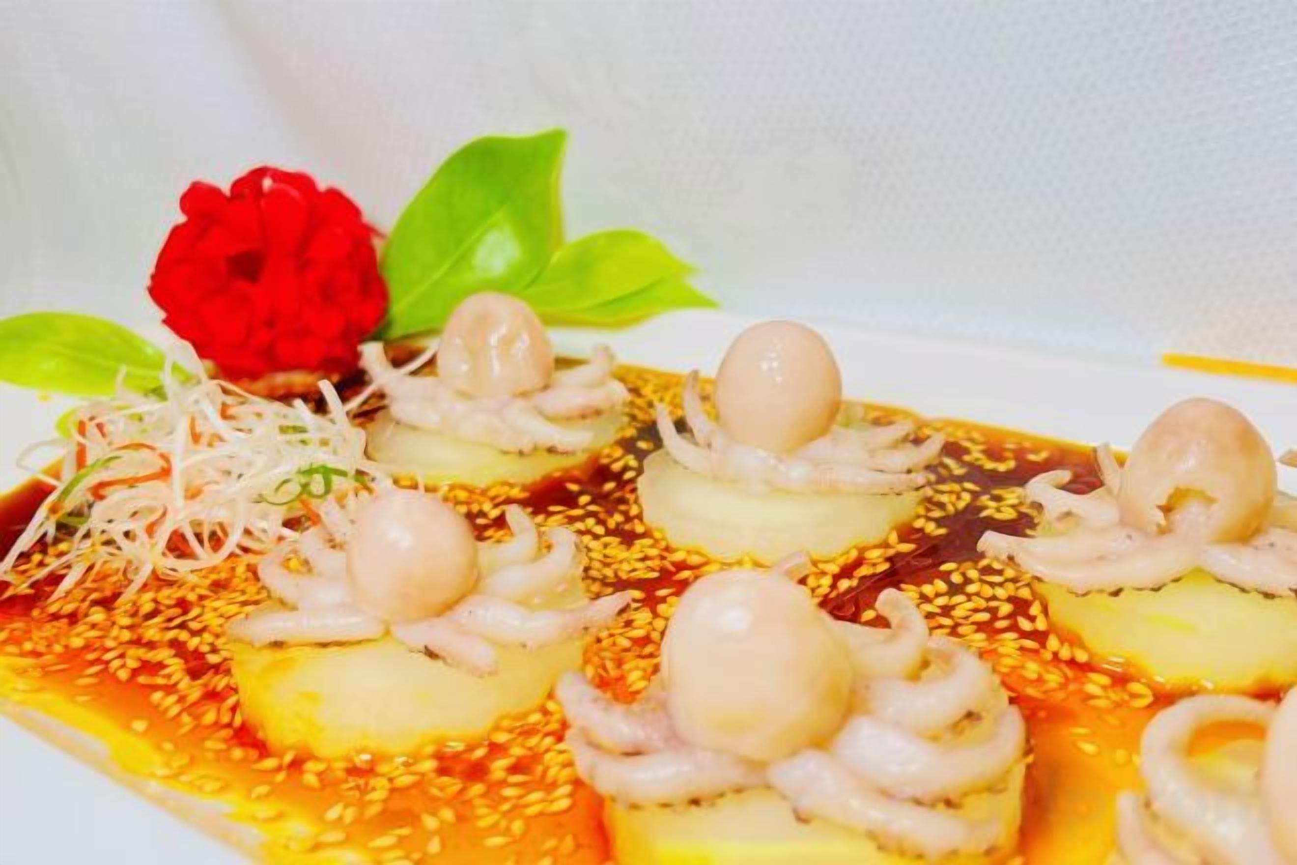 A dish with octopus and sesame seeds.