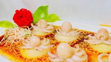 A dish with octopus and sesame seeds.