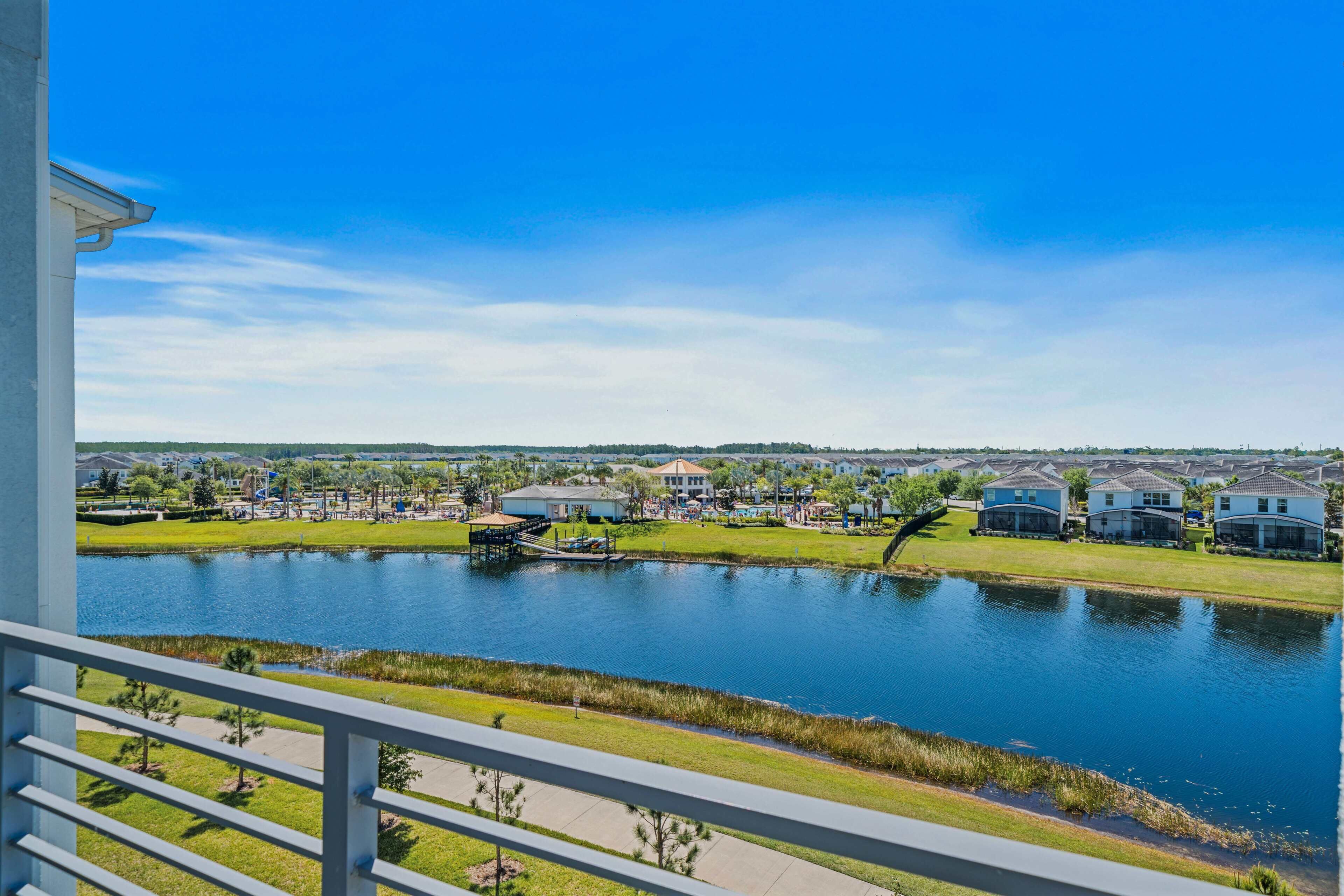 A residential area with a lake, houses, and a dock.