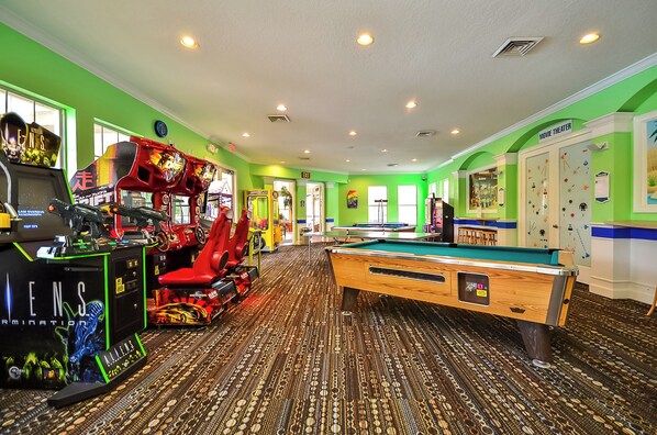 A pool table in a room with green walls and a patterned carpet. - 2301 Butterfly Palm Way #101 (Kissimmee)