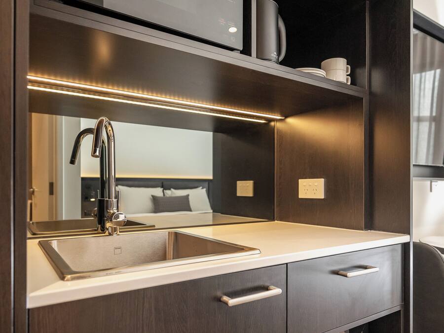 Microwave, coffee/tea maker, cleaning supplies