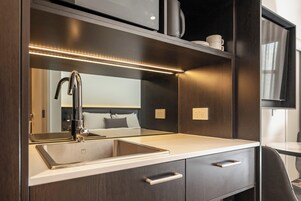 Microwave, coffee/tea maker, cleaning supplies