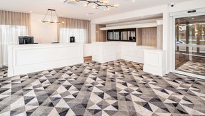 A modern kitchen with white cabinetry, a geometric patterned floor, and pendant lighting. - Mantra Shepparton (Shepparton)