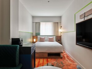 A hotel room with a bed, bedside tables, a desk with a chair, a TV, and a window with curtains. - The Clarence Hotel Sydney by Accor (Sydney)