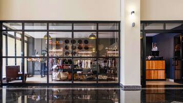 A store with a glass facade, displaying various bags and accessories.