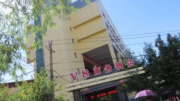 A building with a sign that reads 'V8 Commercial Hotel'.