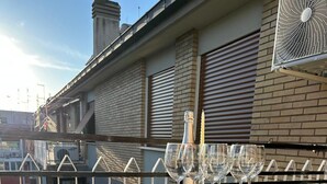 A white metal chair and table on a balcony with a bottle and glasses. - Luxurious apartment, close to the center (Roma)