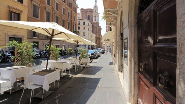 A hotel with outdoor seating, a classic facade, and a prominent entrance. - Spagna Charme - One Bedroom Apartment, Sleeps 4 (Rome)