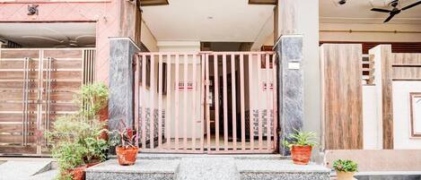A gated entrance with steps leading up to a building.