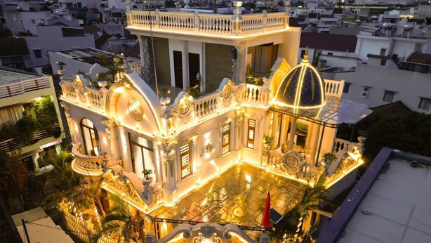A luxurious building with ornate architecture, large windows, and a spacious courtyard. - Cozrum - Cozy Home Phú Yên (Tuy Hoa)