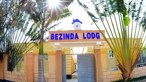A gated entrance to a building with a sign reading "BEZINDA LODG". - Bezinda Lodge (Dodoma)