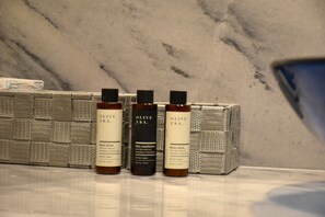 Three bottles of body lotion on a marble countertop. - Porto Castello Villas Trade Winds (Skiathos)