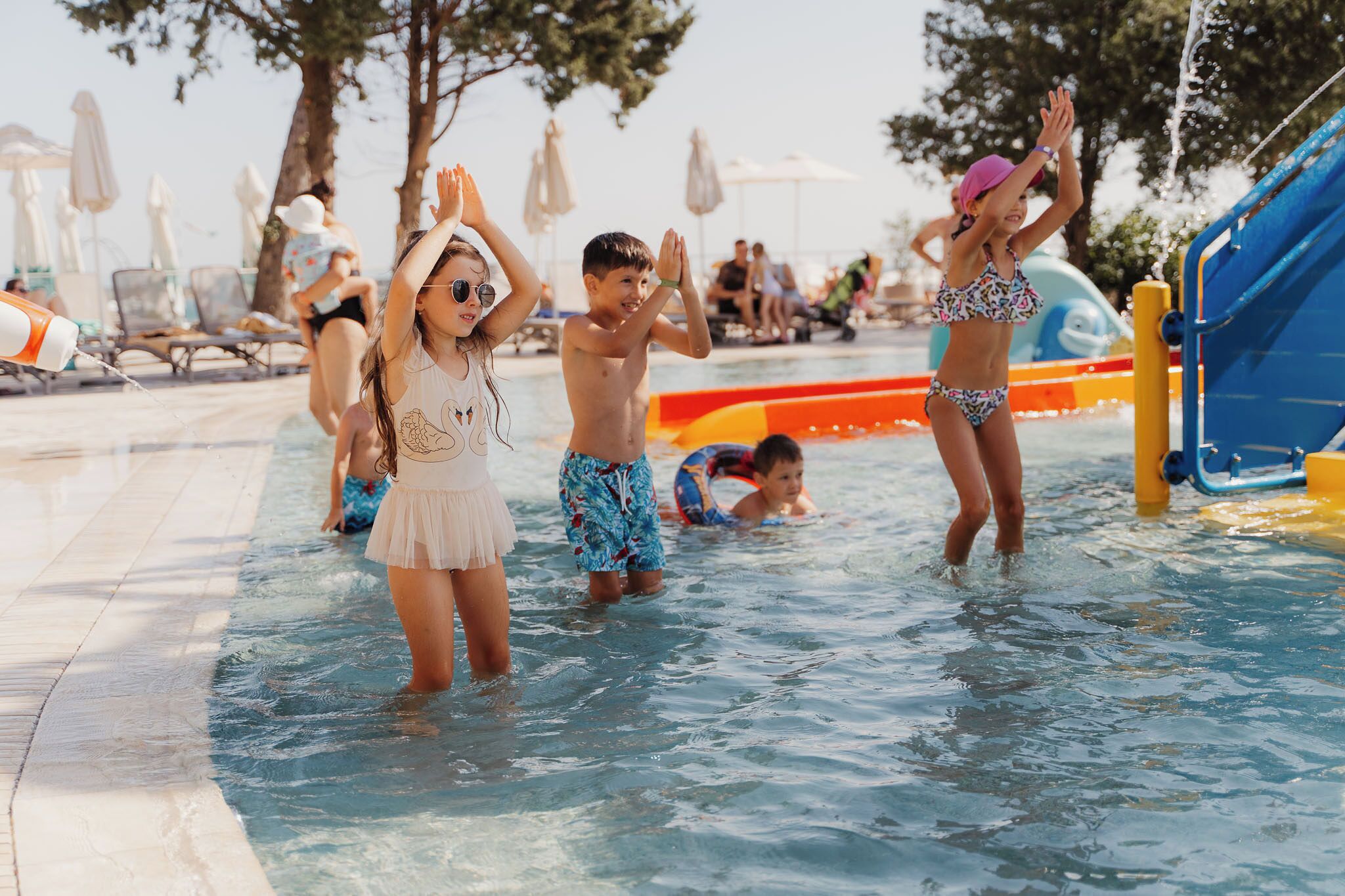 A pool area with water slides and lounge chairs.