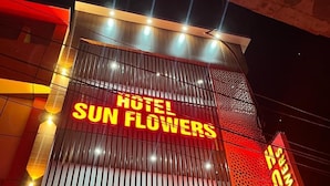 A hotel named 'Hotel Sun Flowers' with a prominent sign and vertical lighting. - Hotel Sun Flowers (Alwar)