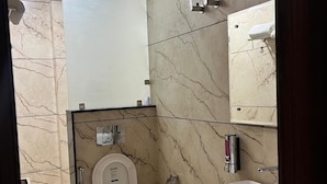 A modern bathroom with a toilet, bidet, and sink. - Hotel Sun Flowers (Alwar)