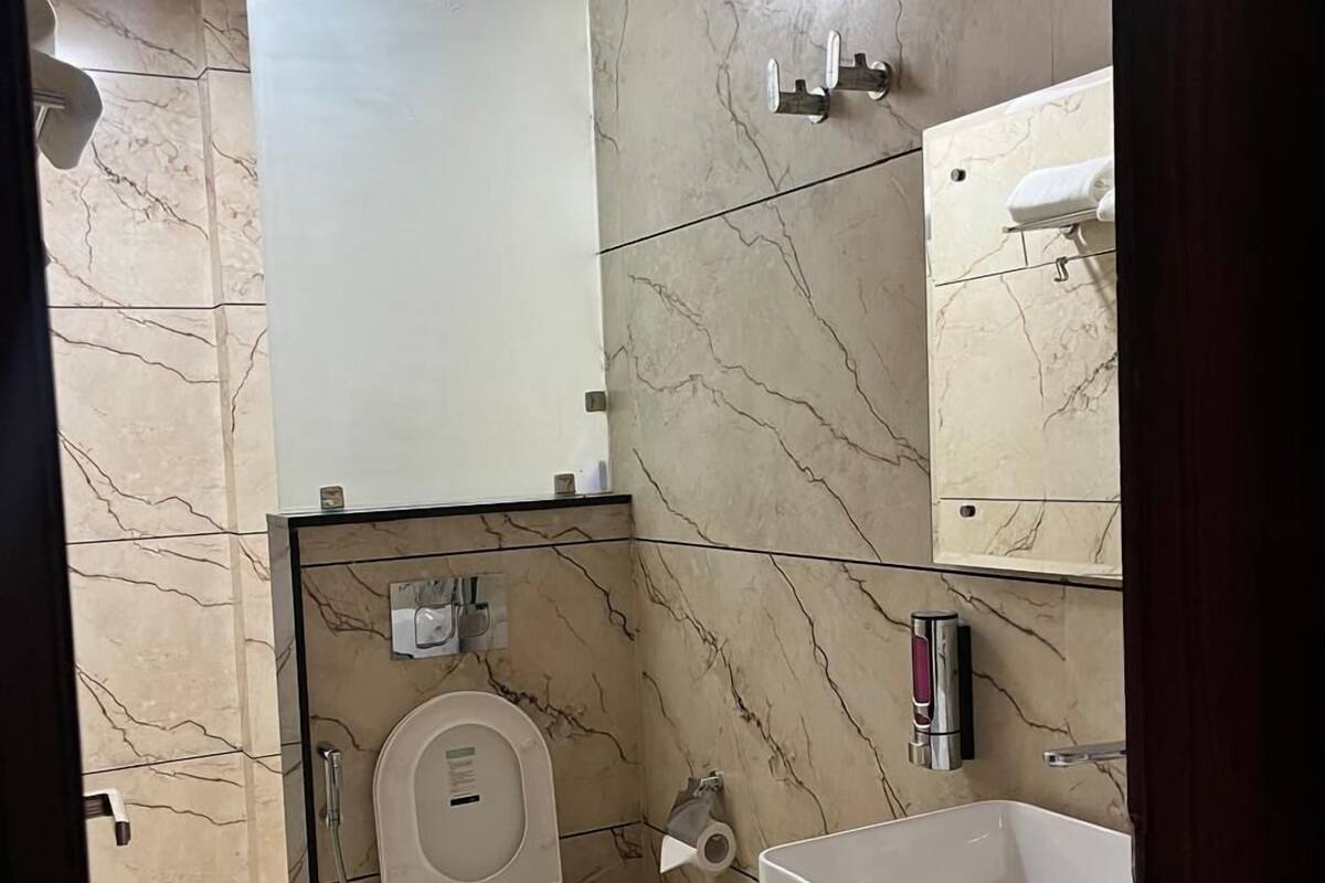 A modern bathroom with a toilet, bidet, and sink.