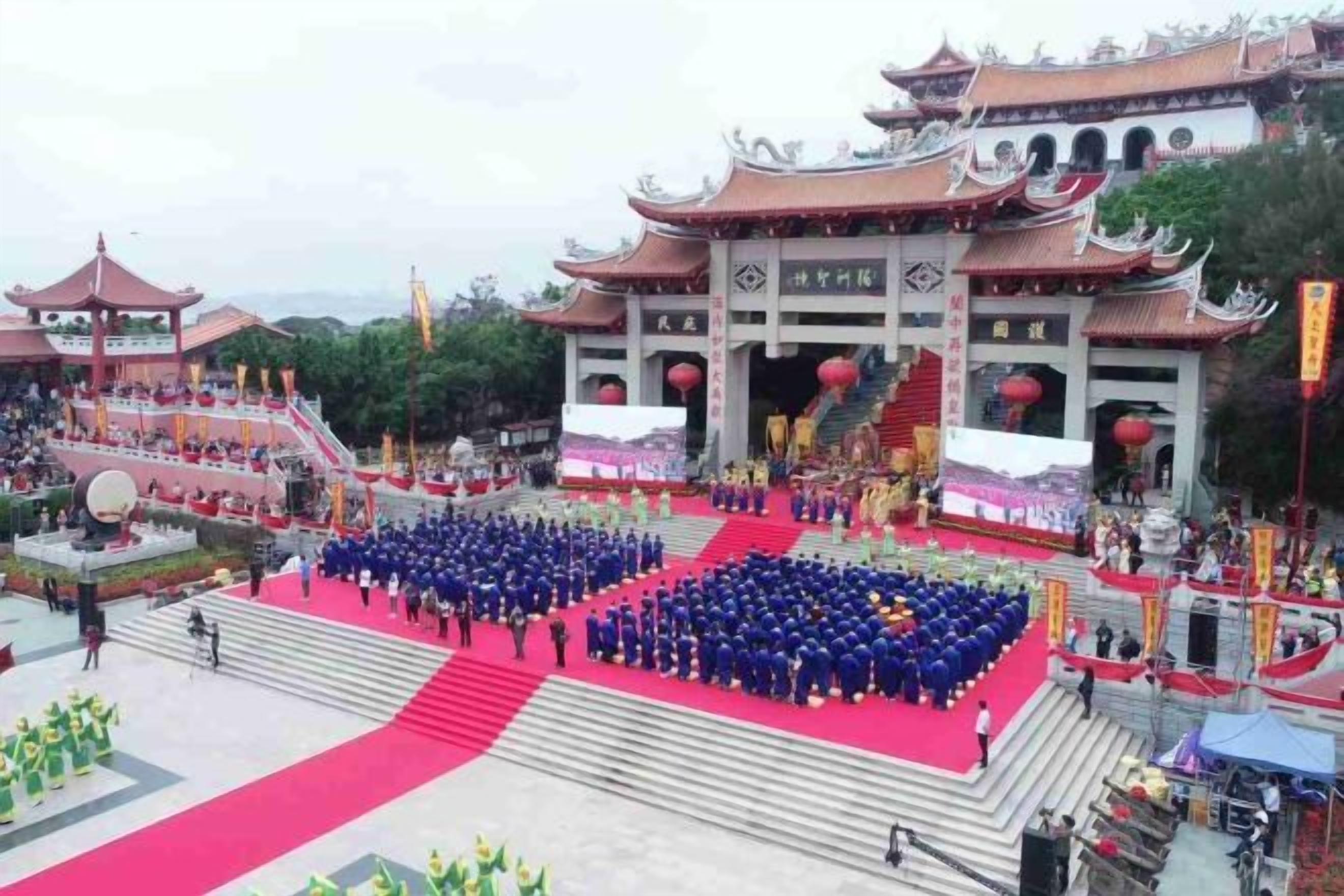 A traditional Chinese architectural structure with a red carpet leading to a stage.