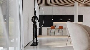 A modern interior with a minimalist design, featuring a dining area with two orange chairs and a white sofa. - Suzhou Sanshan Island Zaidong Farm Boutique Homestay (Suzhou)