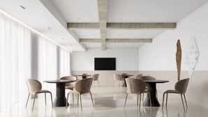 A modern conference room with a large table and chairs, a flat-screen TV, and a minimalist design. - Suzhou Sanshan Island Zaidong Farm Boutique Homestay (Suzhou)
