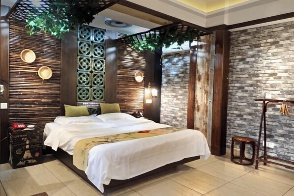 Relax in a serene space with a large bed, wooden paneling, and a stone accent wall.