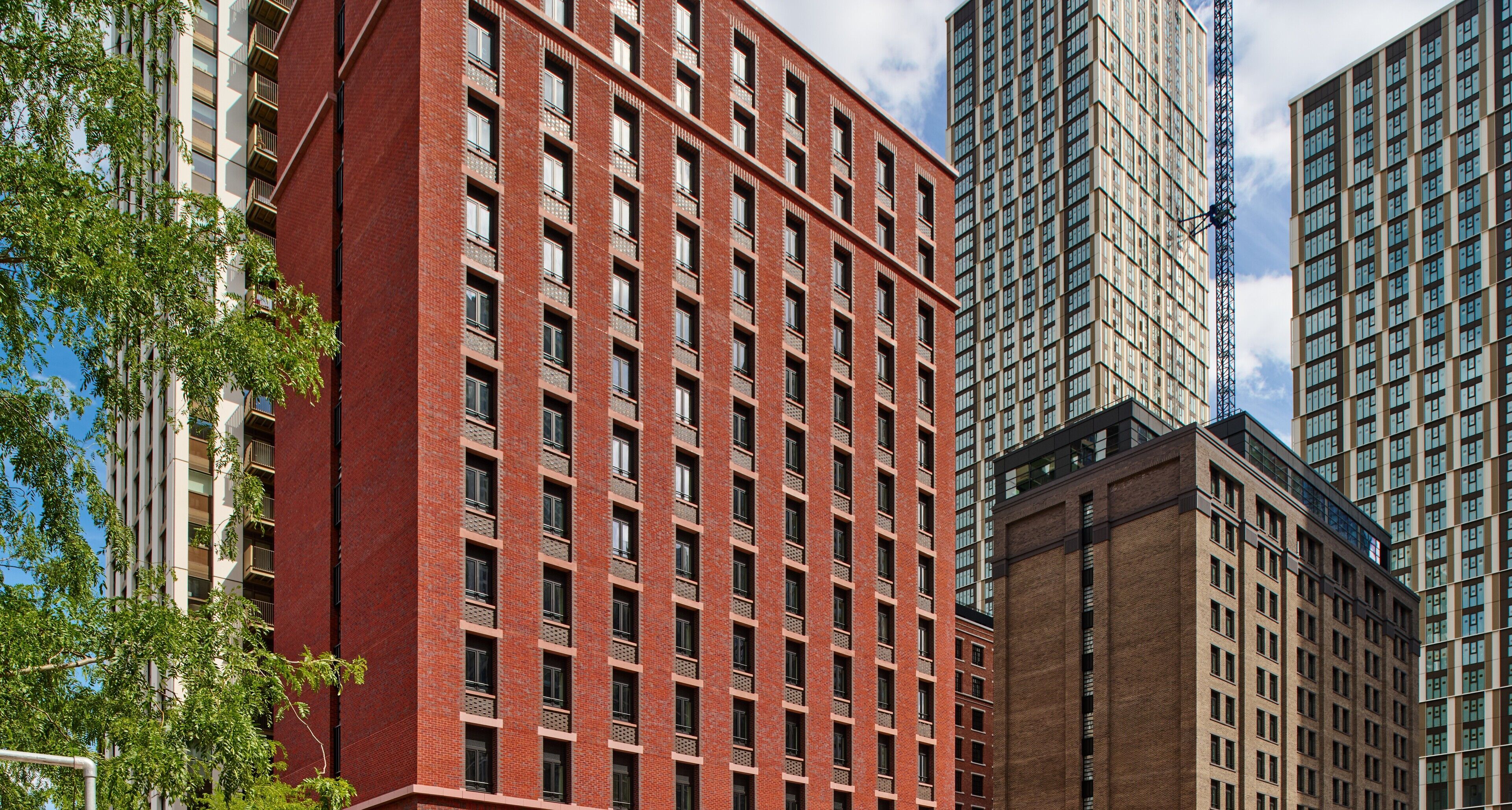 A multi-story building with a red brick facade and numerous windows.