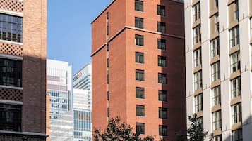 A multi-story building with a brick facade and large windows.