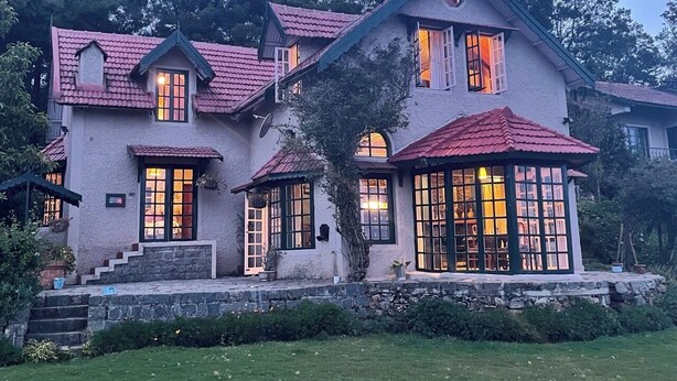 A large, two-story house with a red-tiled roof and multiple windows. - Stumpfields (Ootacamund)