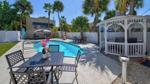 A backyard with a swimming pool, a gazebo, and outdoor furniture. - Apartment for 2 guests (Sarasota)