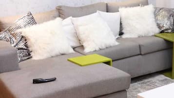 Deluxe Apartment, City View | Living area | 24-inch Smart TV with digital channels