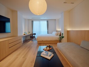 A modern hotel room with a bed, a desk, a chair, a TV, and a large window. - THE SENSE (Tokyo)