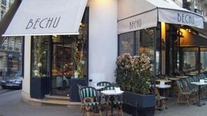 A cafe named BECHU with outdoor seating and a white awning.