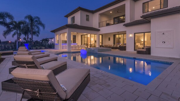 A modern two-story house with a swimming pool, outdoor seating, and a well-lit patio area. - The Superhero Haven-TT276 (Kissimmee)