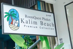 Schild für RoomQuest Phuket Kalim Beach Premium Collection.