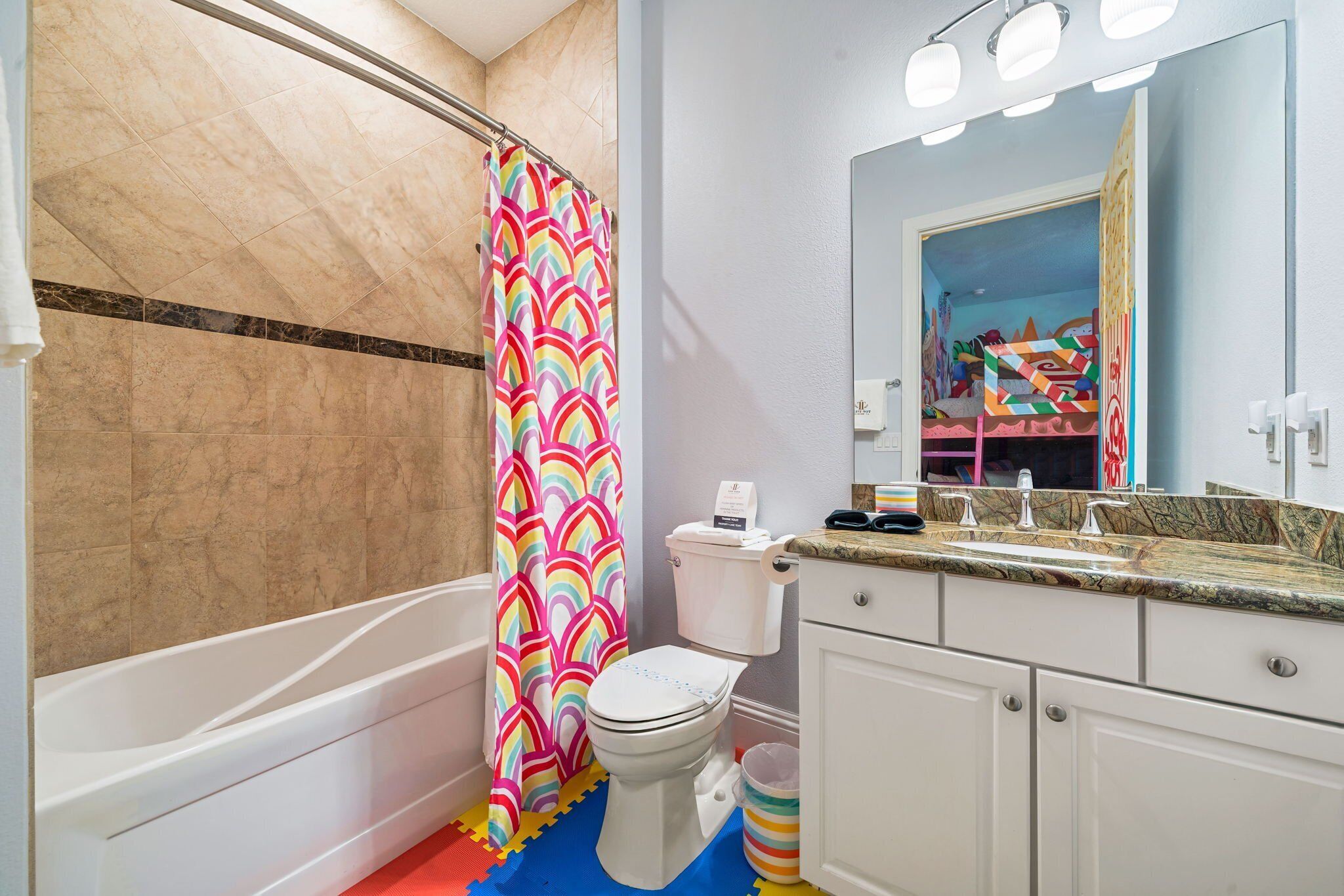 A bathroom with a bathtub, toilet, and sink.