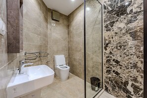 A bathroom with a marble shower, a white sink, and a toilet. - Styling 5 BR Duplex Apartment (First 6th of October)