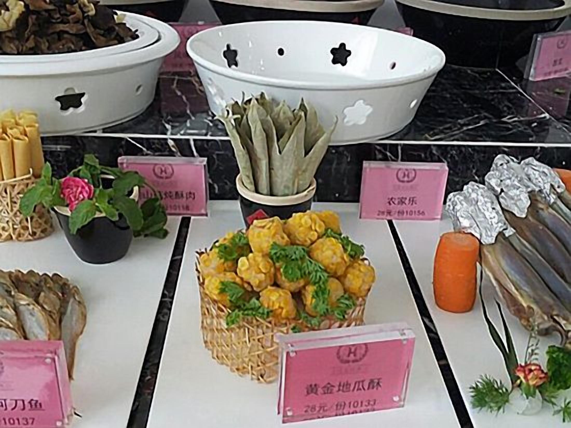 A buffet with various food items and price tags.