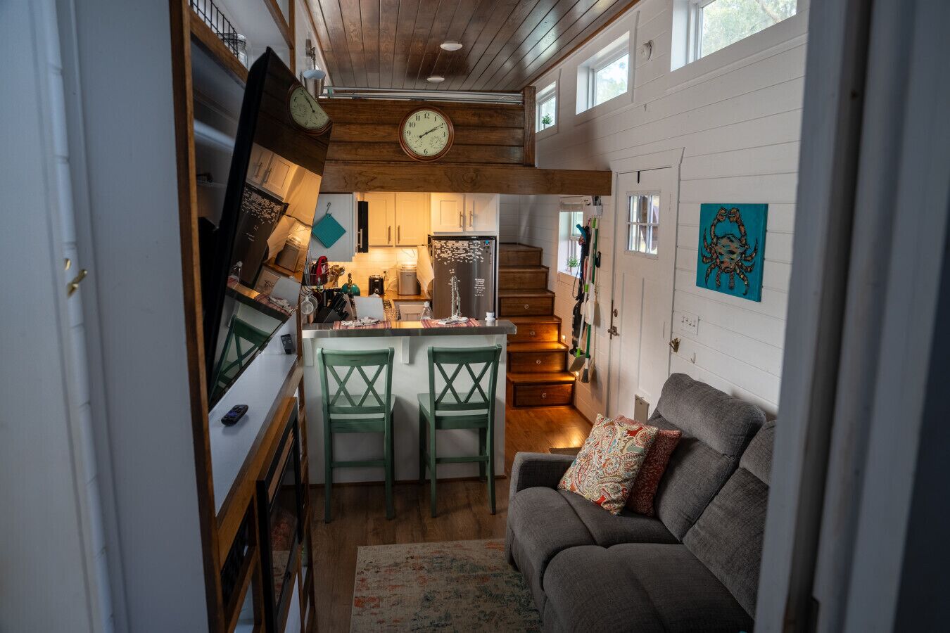 A cozy interior with a kitchen, dining area, and a living room with a couch.