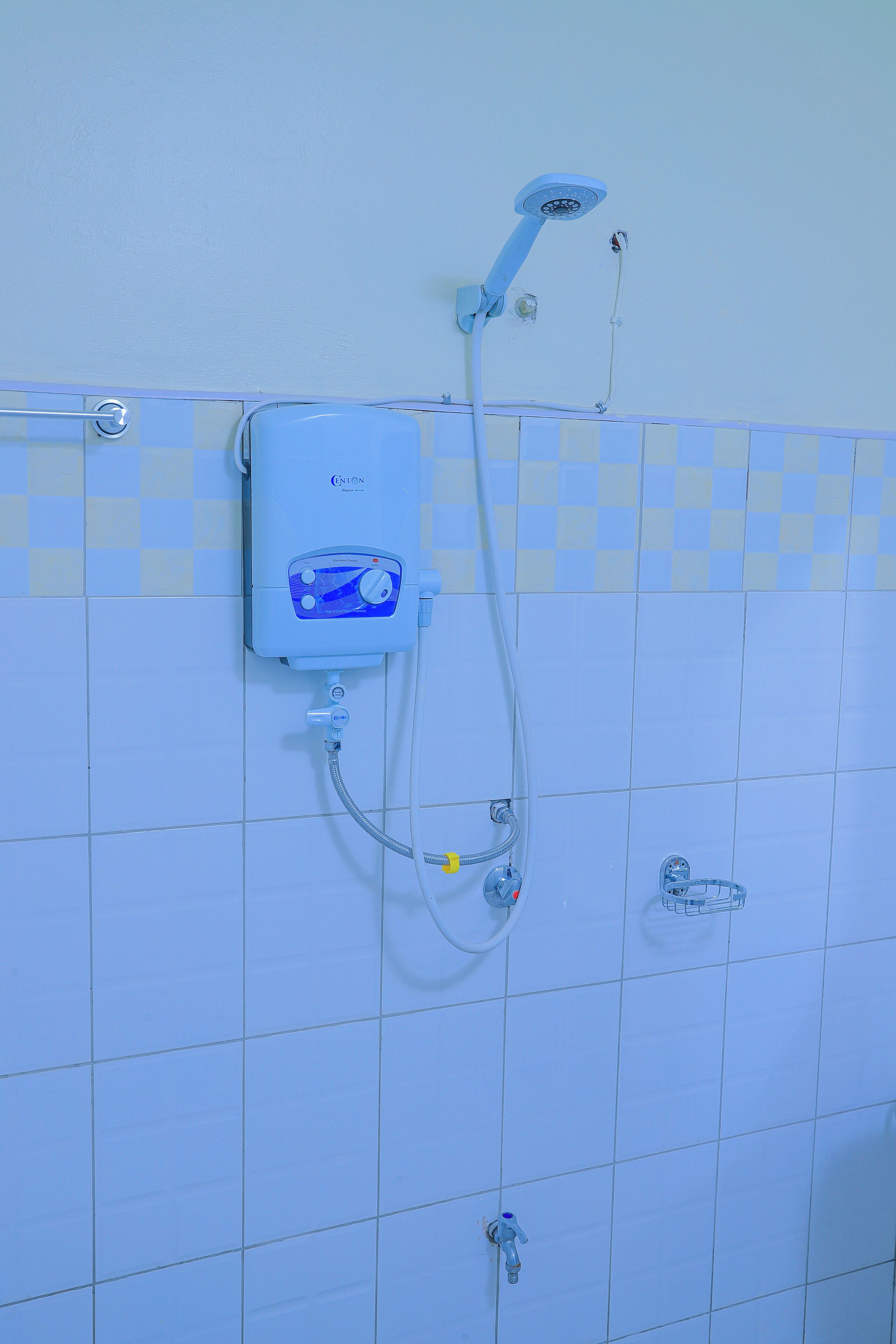 Un baño con ducha empotrada, cabezal de ducha manual y grifo monomando.