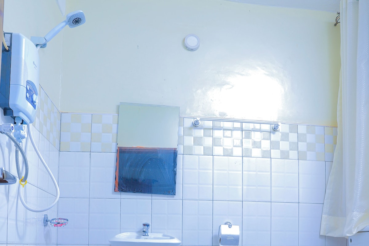 A bathroom with a toilet, sink, and shower.
