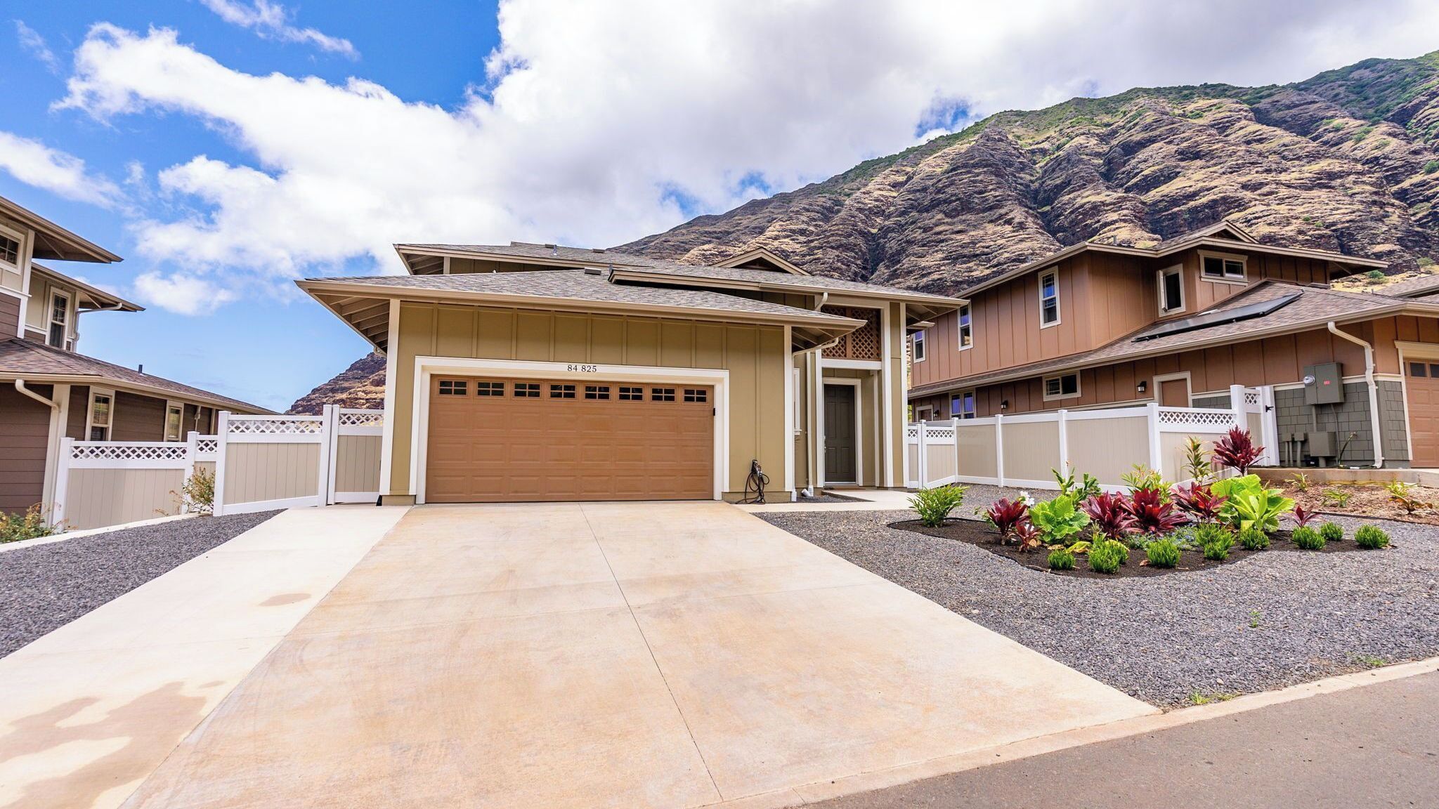 A residential property with a garage, a driveway, and a landscaped garden.