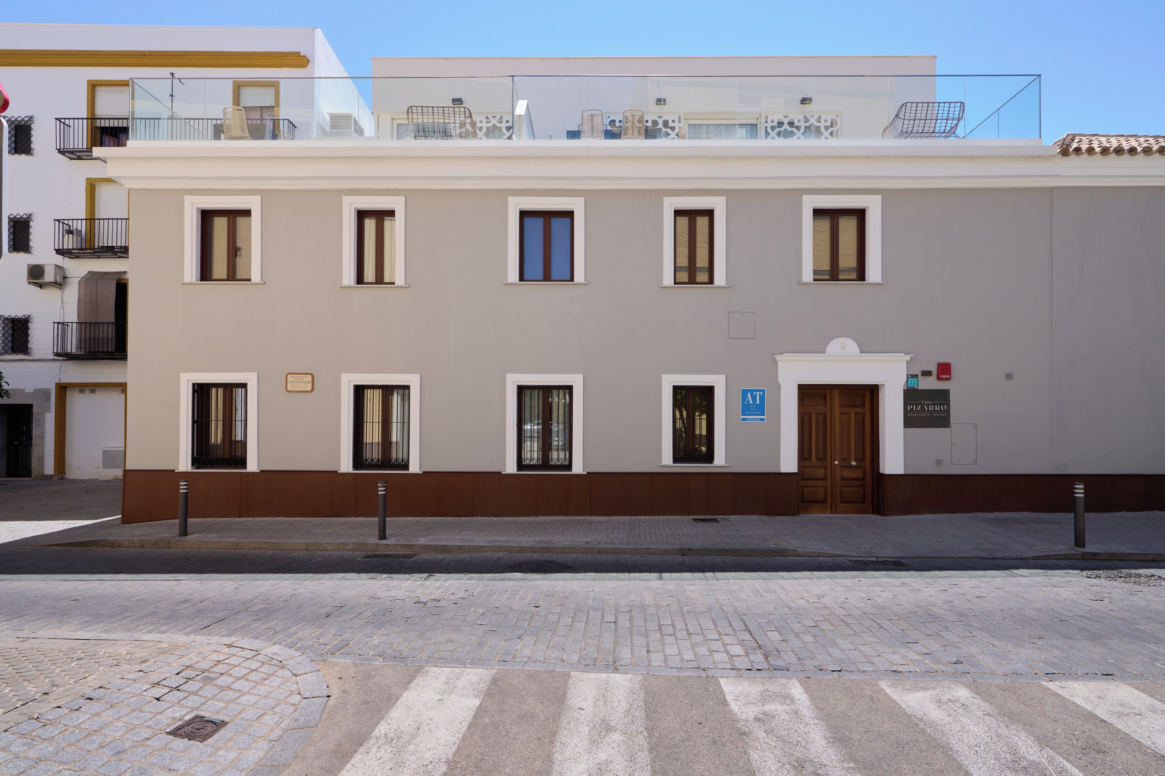 A multi-story building with a flat facade, multiple windows, and a ground-floor entrance.