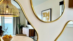 A dining area with a round table, a bowl of lemons, and a pendant light. - Casa Fifi Coral (Miami Beach)