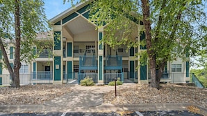 A multi-story building with a central courtyard, featuring balconies and a covered walkway.