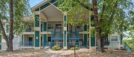 A multi-story building with a central courtyard, featuring balconies and a covered walkway.