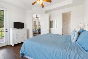 A bedroom with a bed, a dresser, a television, and a ceiling fan. - Stone Cliff Relaxation w/ Resort Amenities! (Branson)