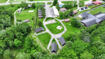 An aerial view of a residential area with houses, roads, and green spaces.