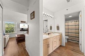 A modern bathroom with a shower, vanity, and a large mirror. - Peaceful Lakeview Escape - For 6 (Branson)
