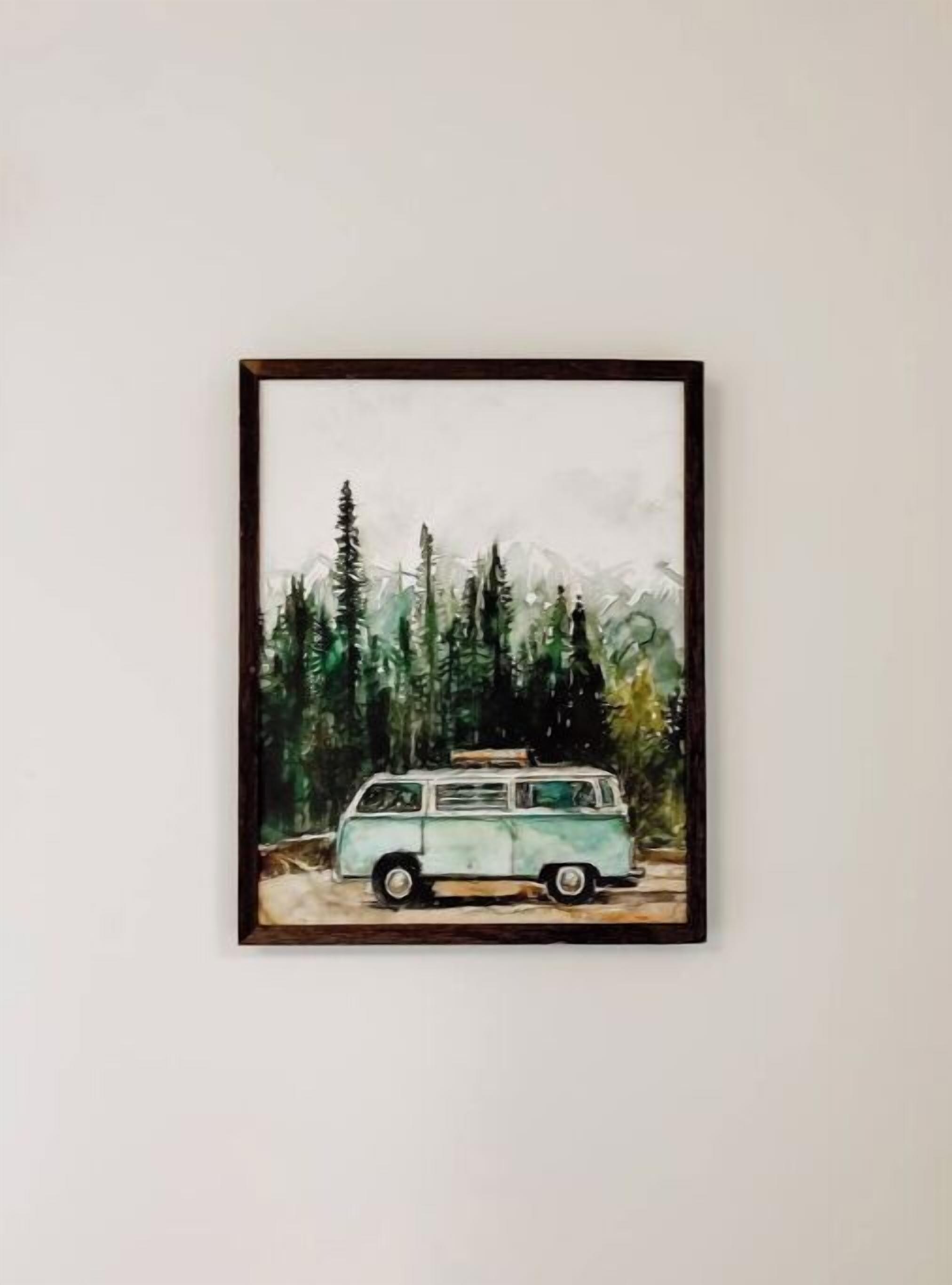 A framed painting of a vintage van parked in a forest.