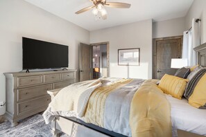 The final suite includes a plush queen bed, ensuite, Smart TV, & patio access